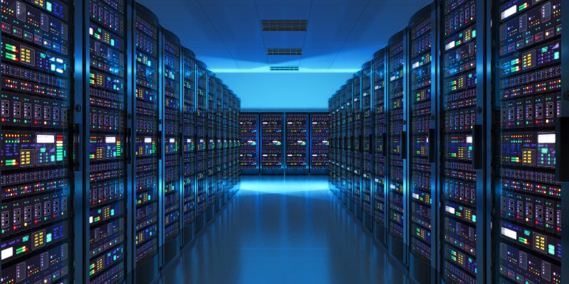 A dimly lit server room featuring rows of high-tech servers with colorful lights and displays, creating a futuristic atmosphere.